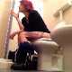 A short-haired brunette girl with dyed highlights sits down on a toilet, lights a cigarette, takes a shit with a few audible wet-sounding plops, and then pisses. Unfortunately, some annoying dog barks in the background. Over 4.5 minutes.